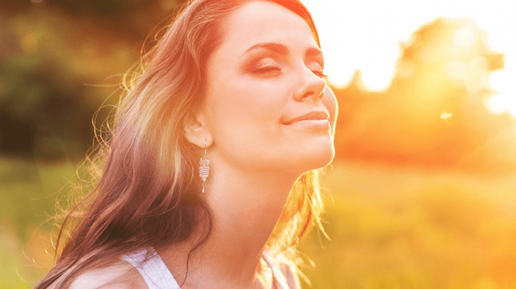 How happy are you - a lady gazing into the summer sun and measuring her happiness