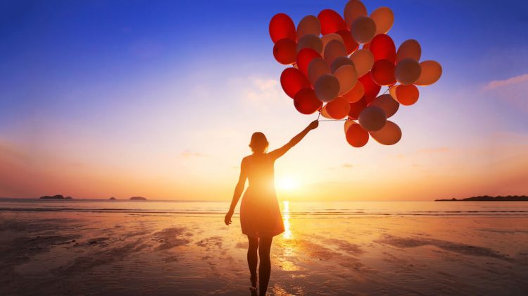 Change your thoughts change your life a woman looking at the horizon letting go of life balloons getting in the way of living life to the full
